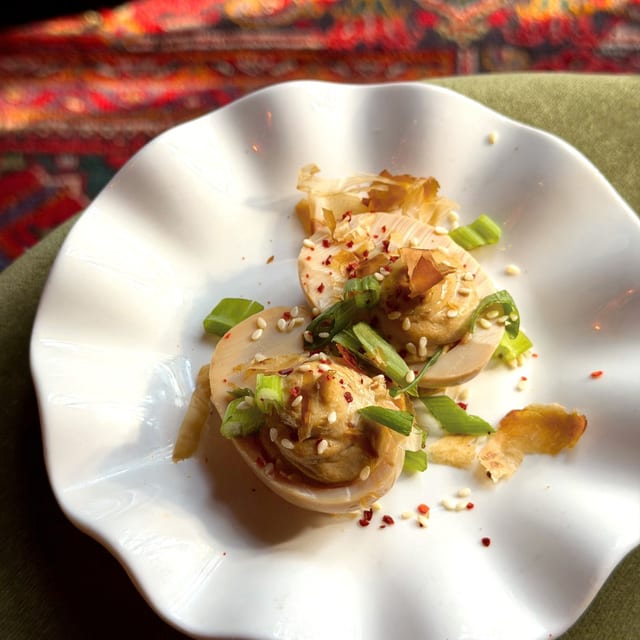 Black Garlic Deviled Egg (Two Halves).